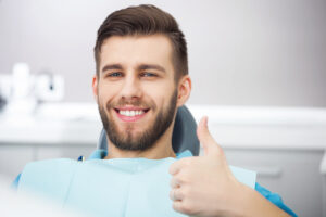 Portrait of happy patient in dental chai