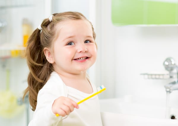 child brushing her baby teeth