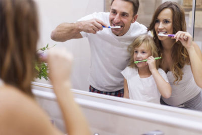family showing proper brushing