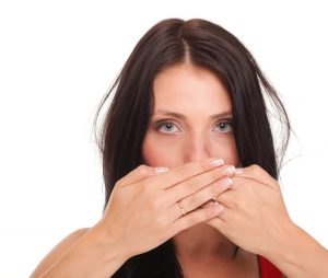 woman covering her mouth