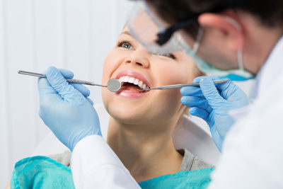 girl at dentist getting tooth extraction